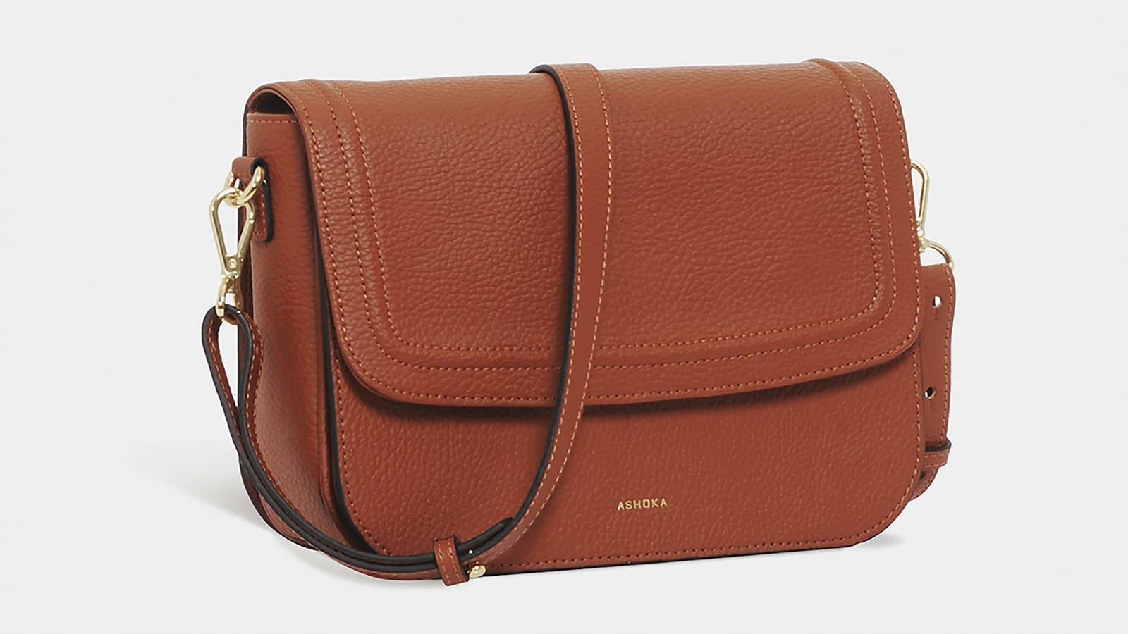 brown leather sling bag on white background