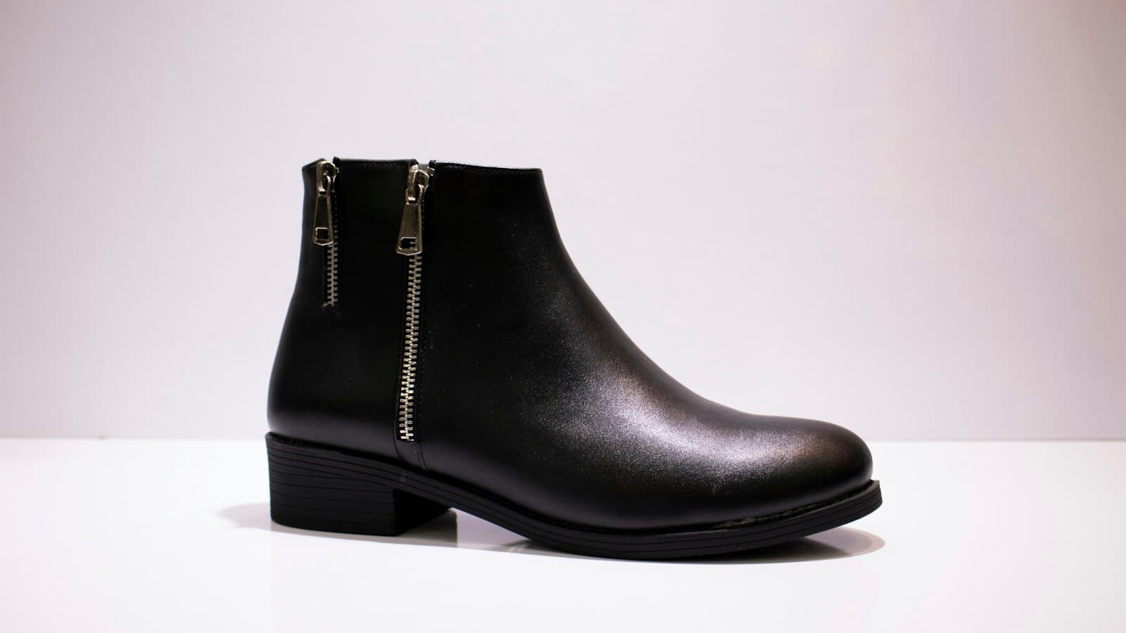 black leather boot on white table
