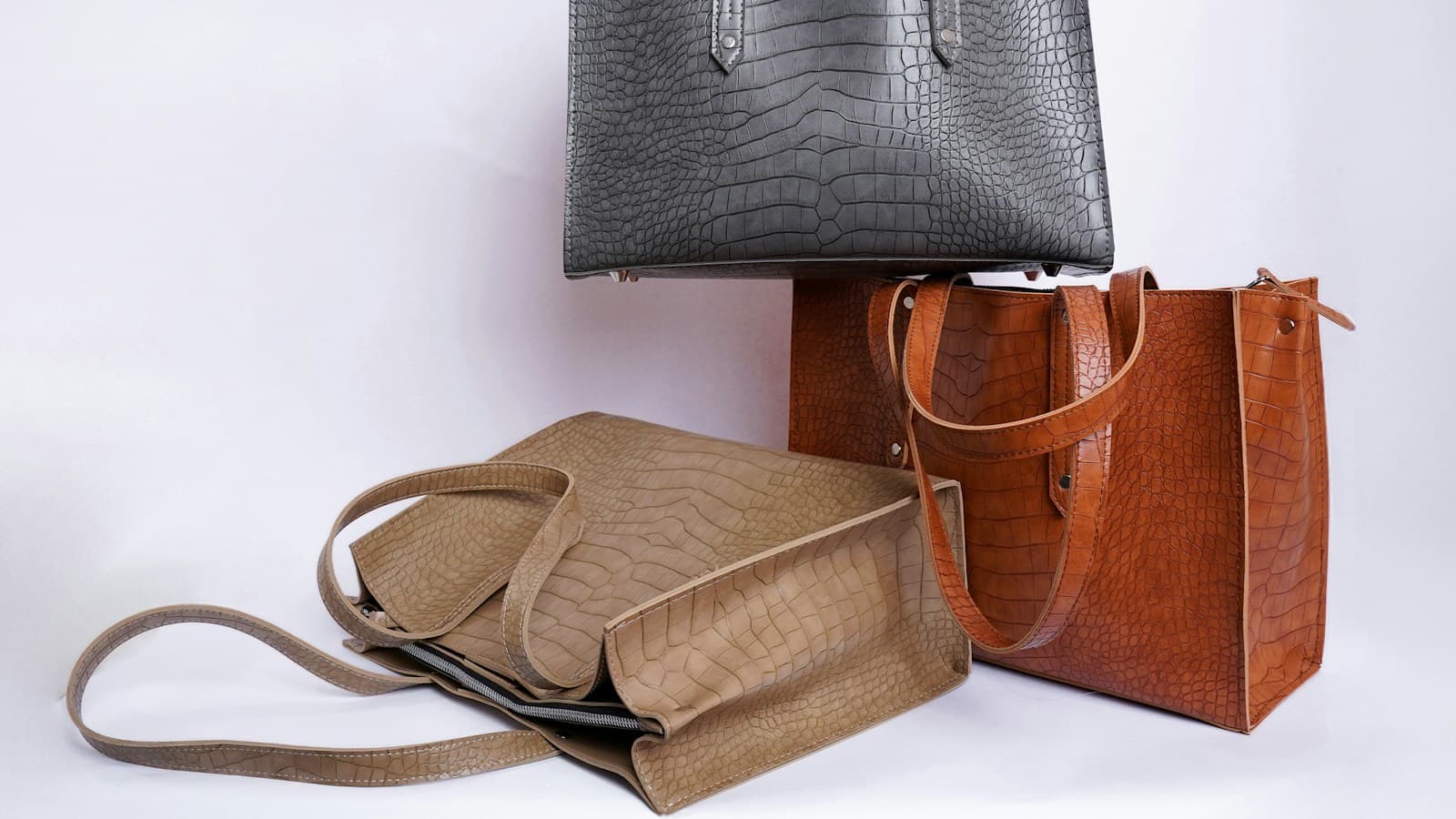 three different types of purses on a white background