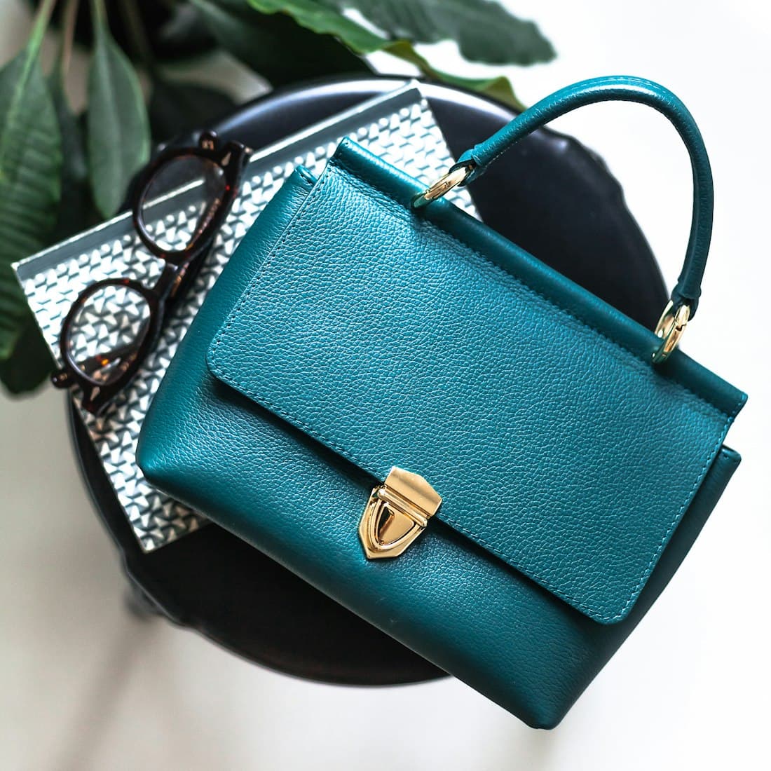 blue leather handbag on black leather bag