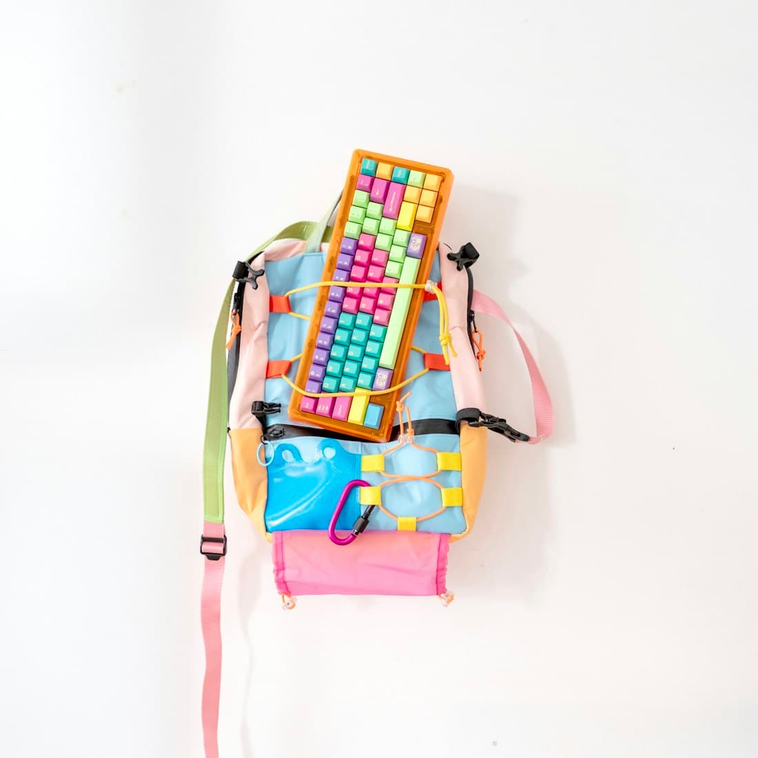 Colorful backpack with attached keyboard and carabiner