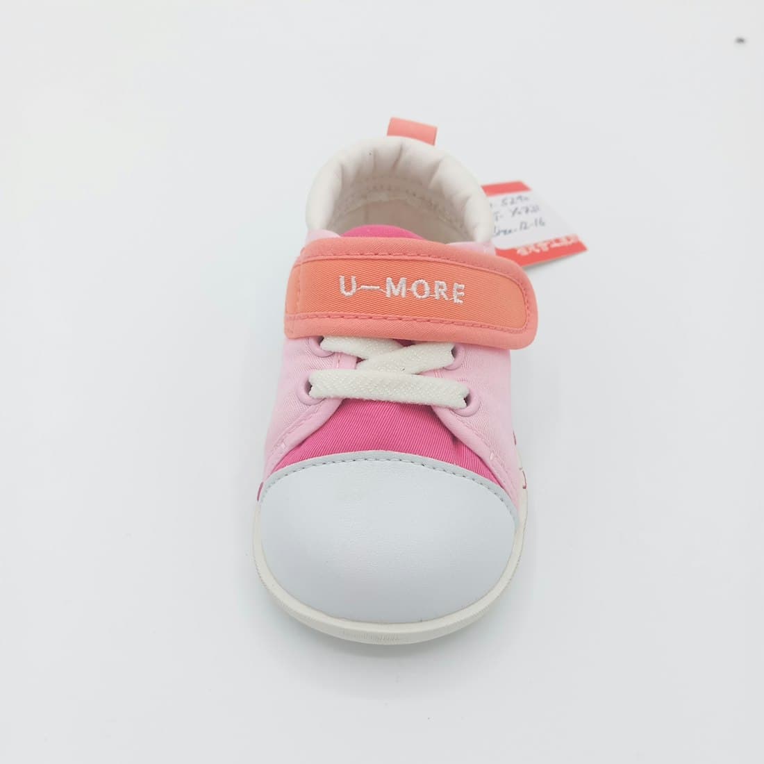 A pink and orange child's shoe with laces