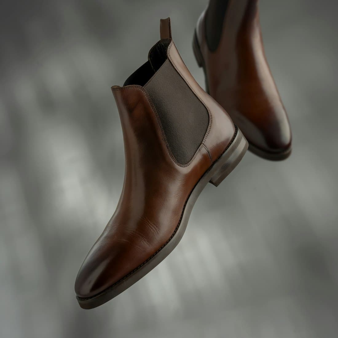 A pair of polished brown leather chelsea boots
