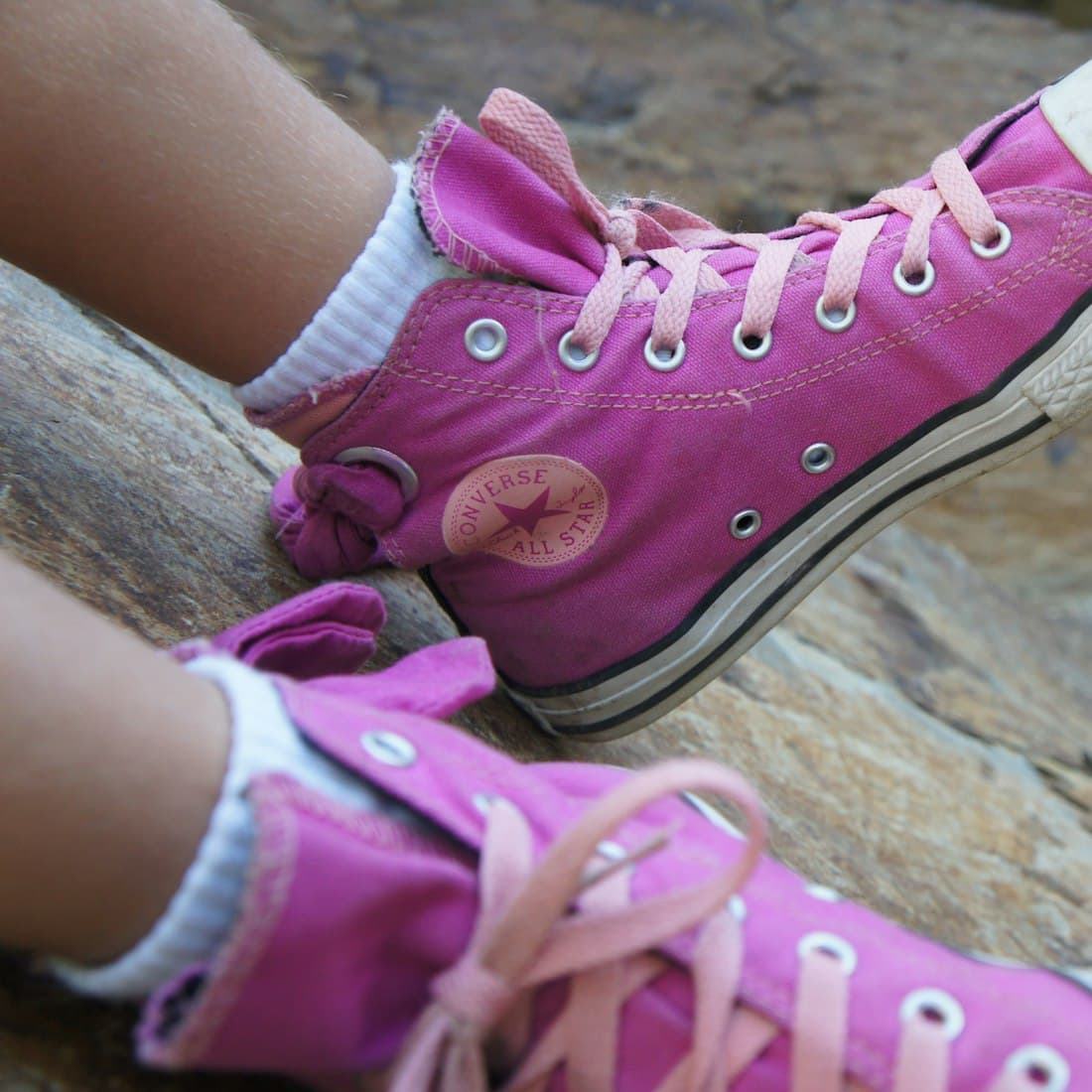 a close up of a person wearing pink shoes