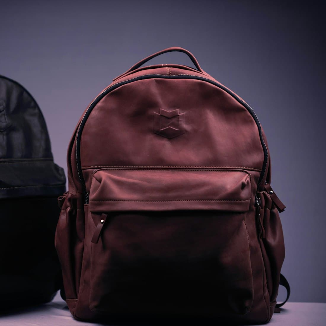black and brown backpack on white textile