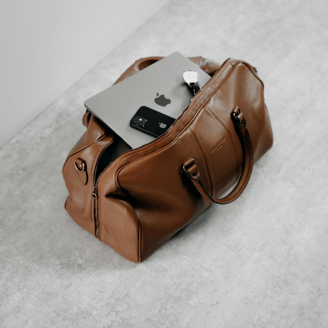 a brown purse sitting on top of a white floor