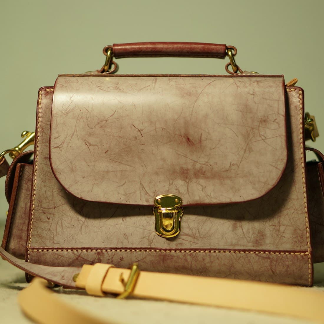 a brown purse sitting on top of a table