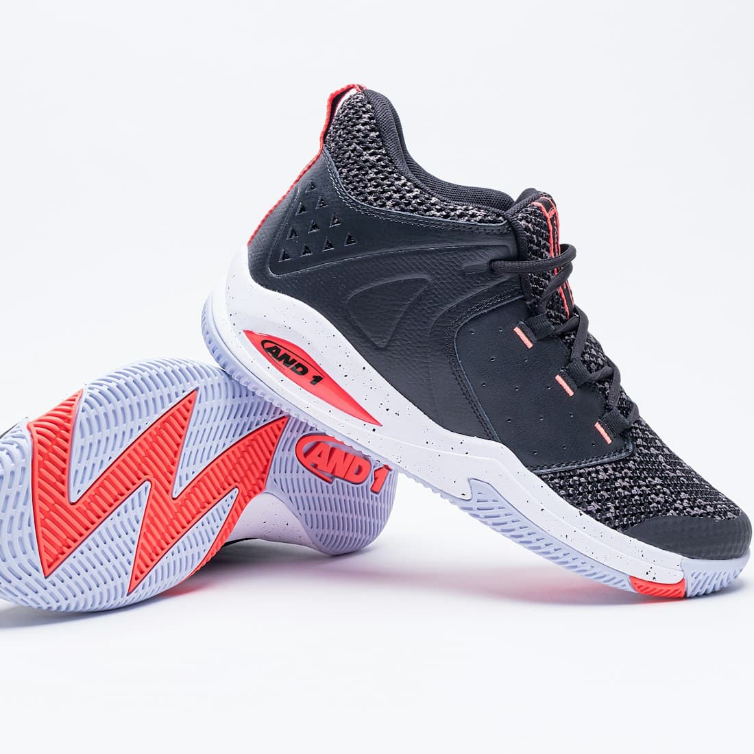 a pair of black and red shoes on a white background