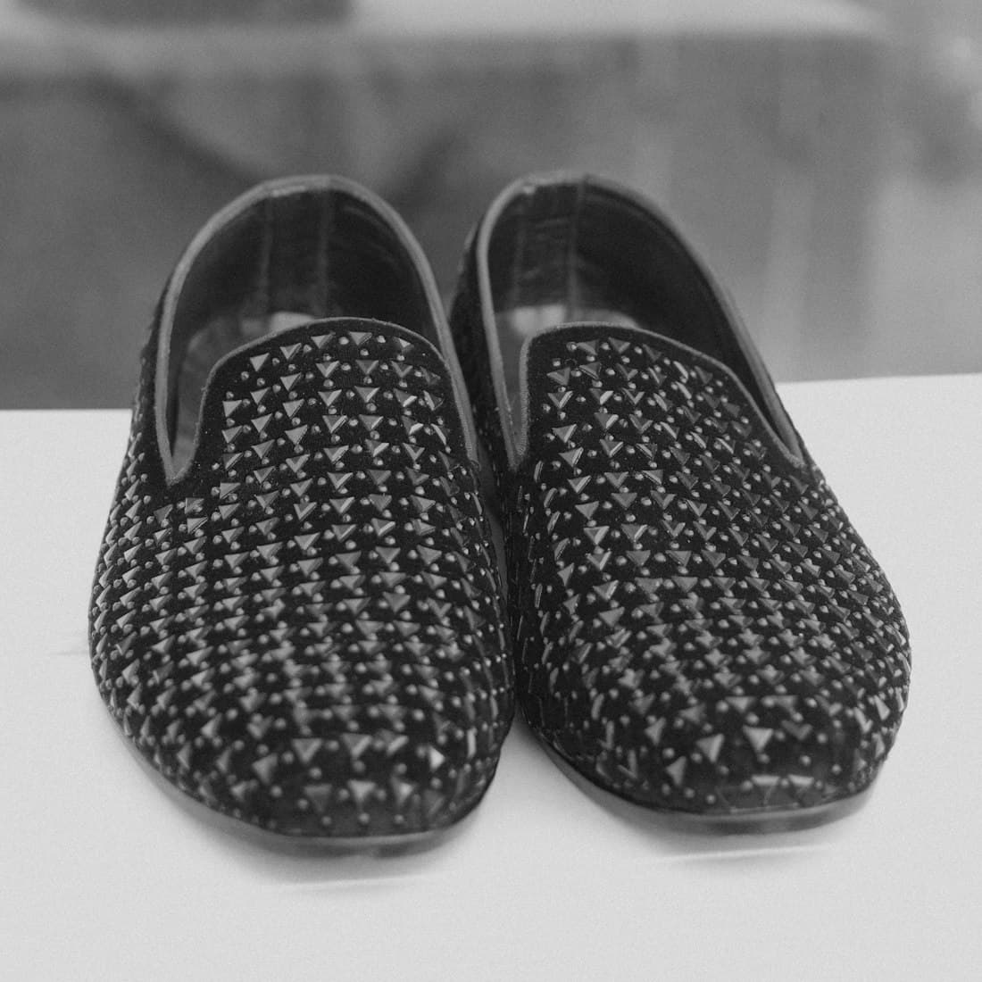 A pair of patterned slip-on shoes in black and white