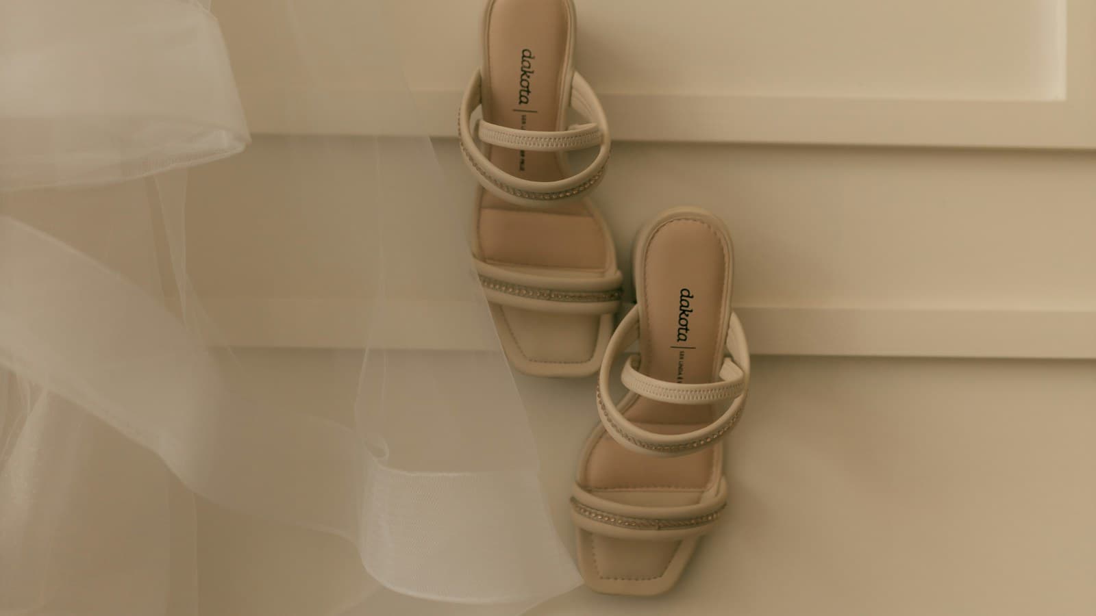 A pair of beige strappy heeled sandals