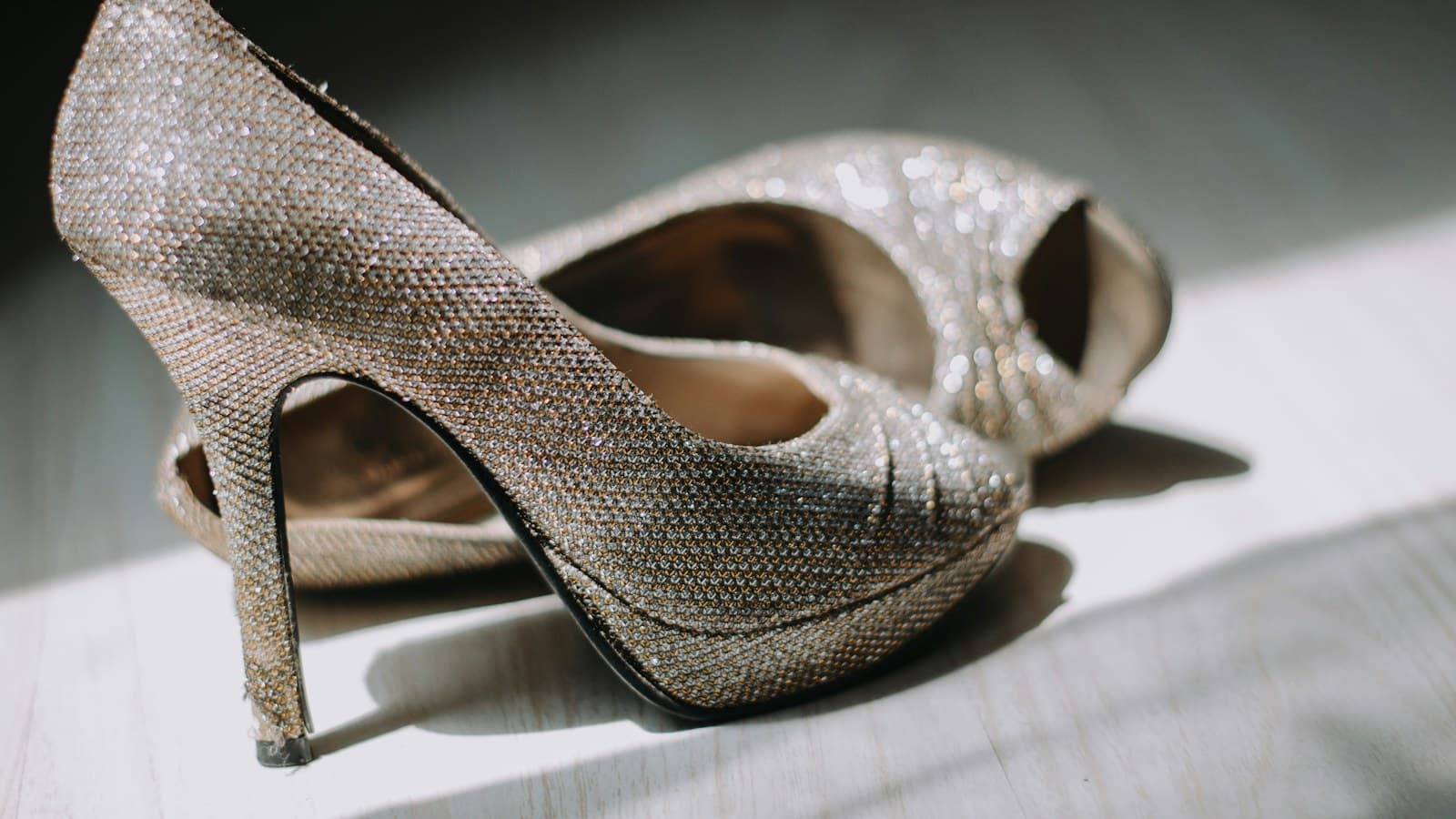 close up photography of pair of silver leather platform stilettos