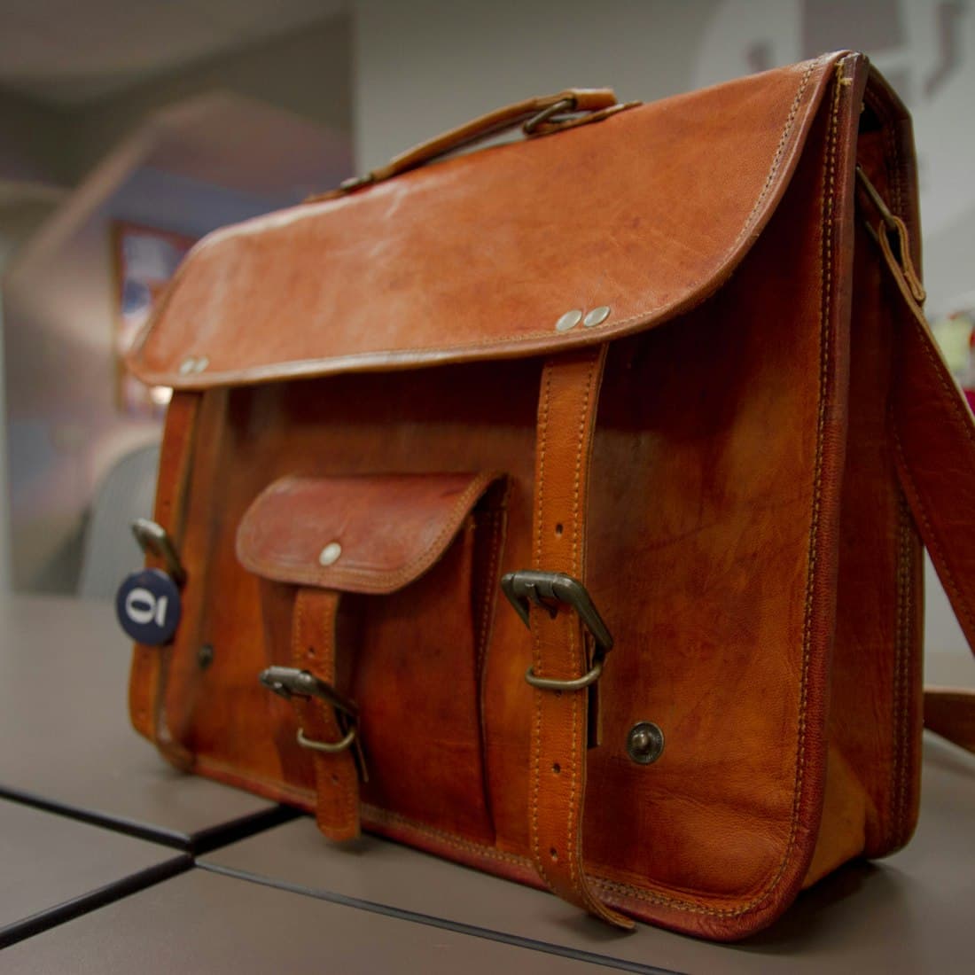 closeup photo of brown leather crossbody bag