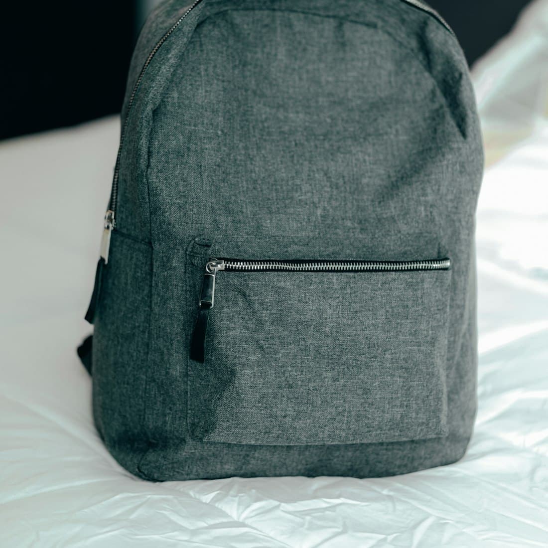black backpack on white textile